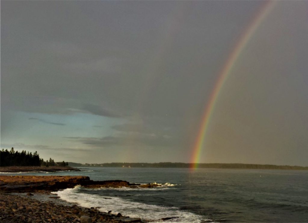 Double rainbow over seawall