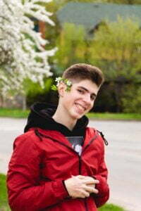 Boy with flowers over his ear. Bach Flowers are great for children!