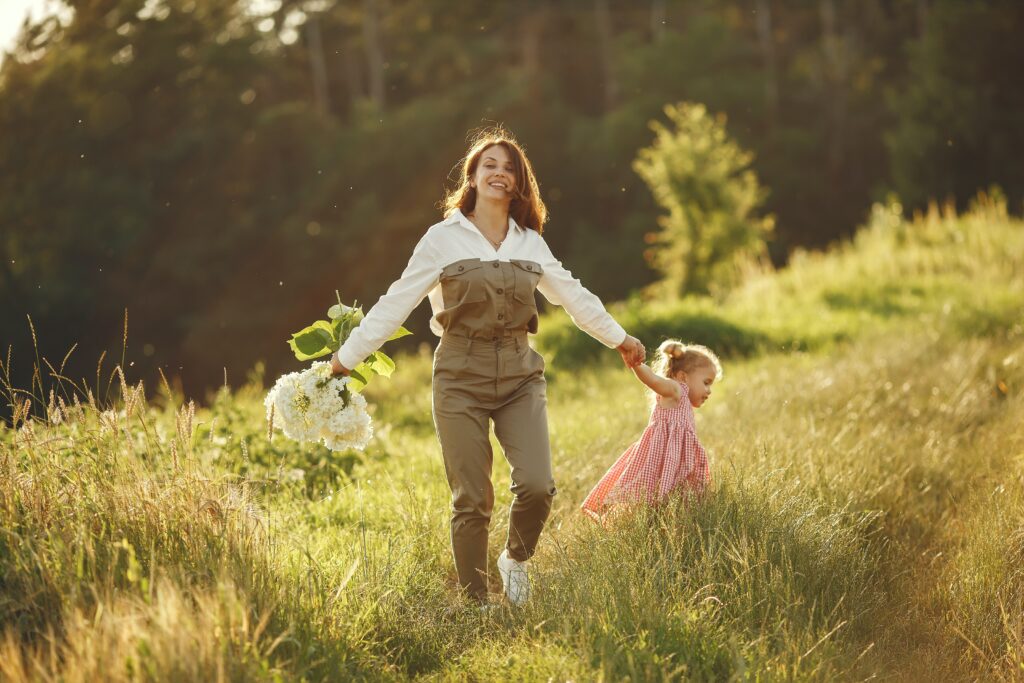 Mother and daughter in field with flowers. Flower essences are wonderful for children and families!