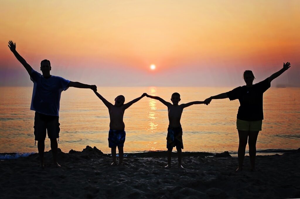Family at Sunset holding hands reminds us that we need one another.