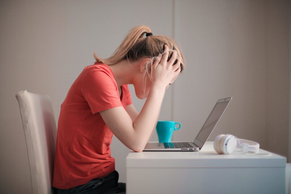 Girl in distress at her computer.We all need help coping with climate anxiety.
