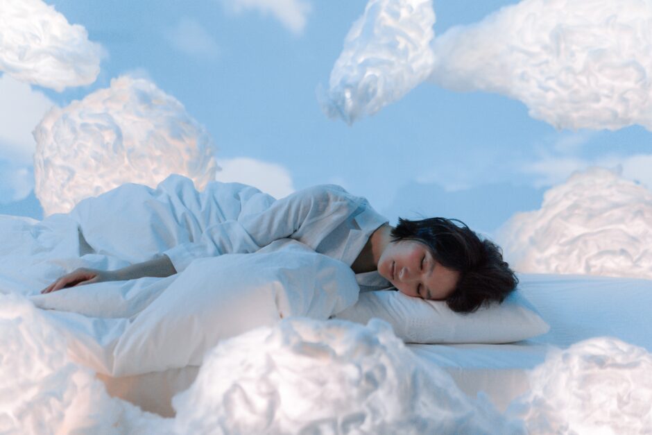 Woman dreaming in the clouds as a symbol of dream work and intuition.