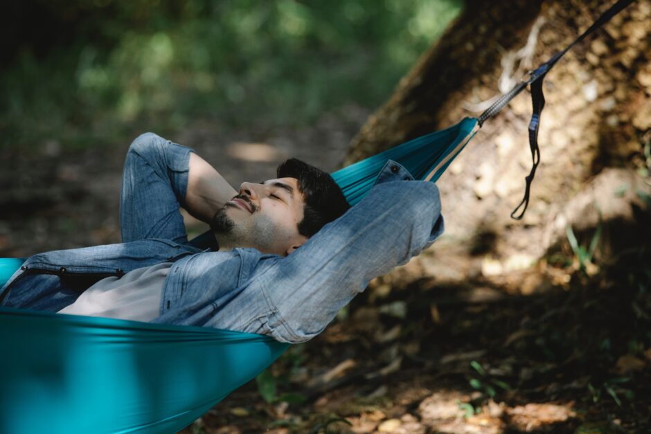 Man in hammock in forest experiencing ecotherapy!