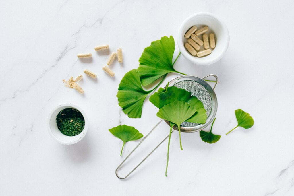 Herbs and pills on a white table. Botanical medicine health products helps heal body, mind, and soul.