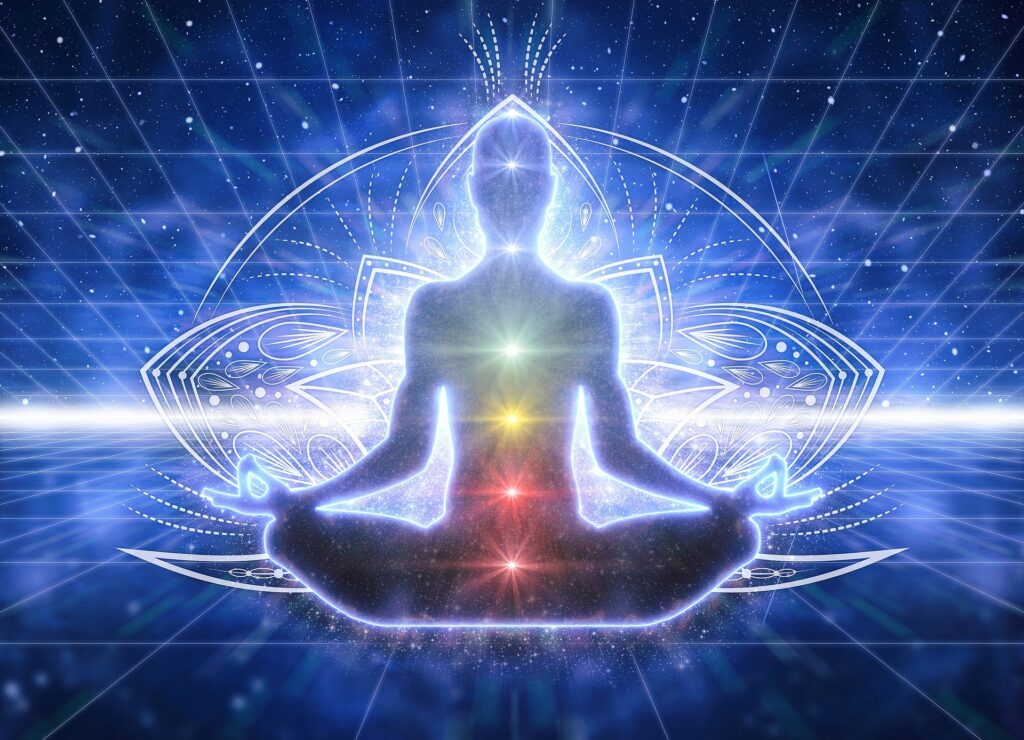 Image of Yoga meditation pose with colored energy centers