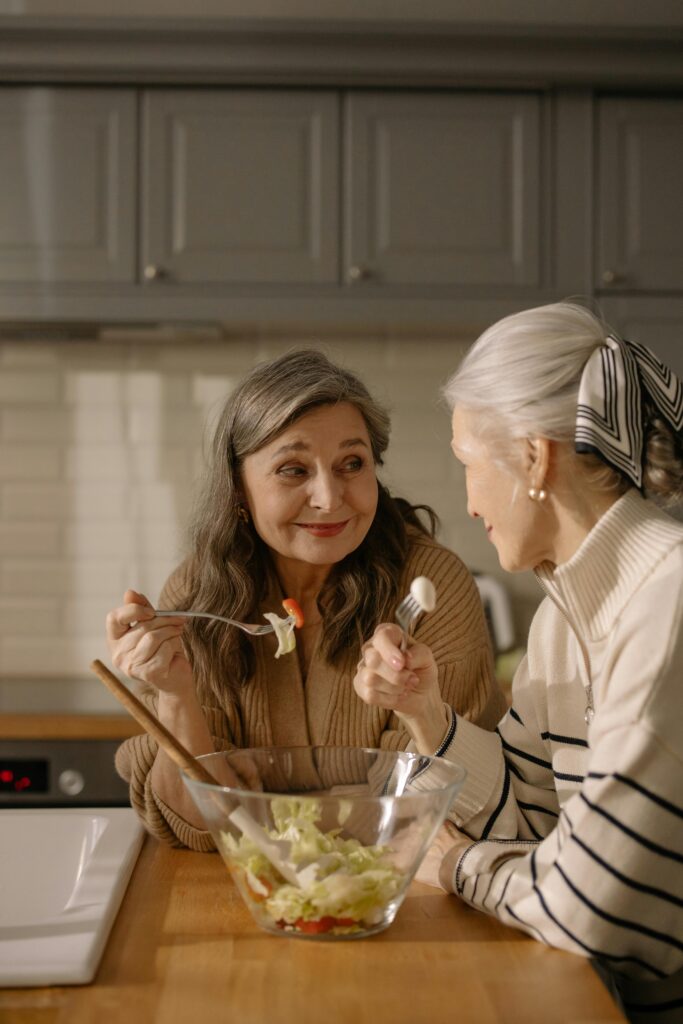 Two women bonding over food and sharing.