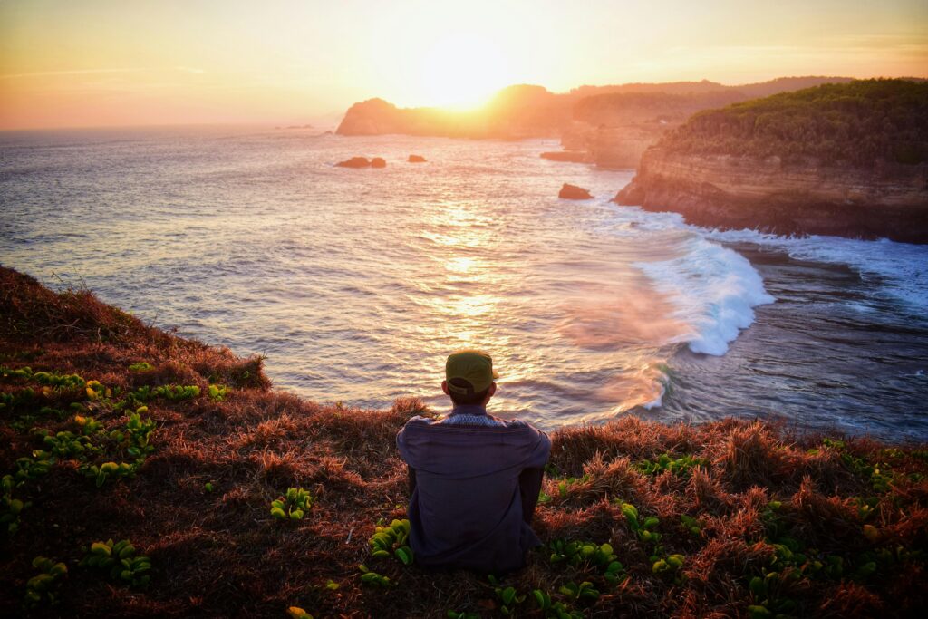 Man meditating by the sea. Meditation enhances personal growth.