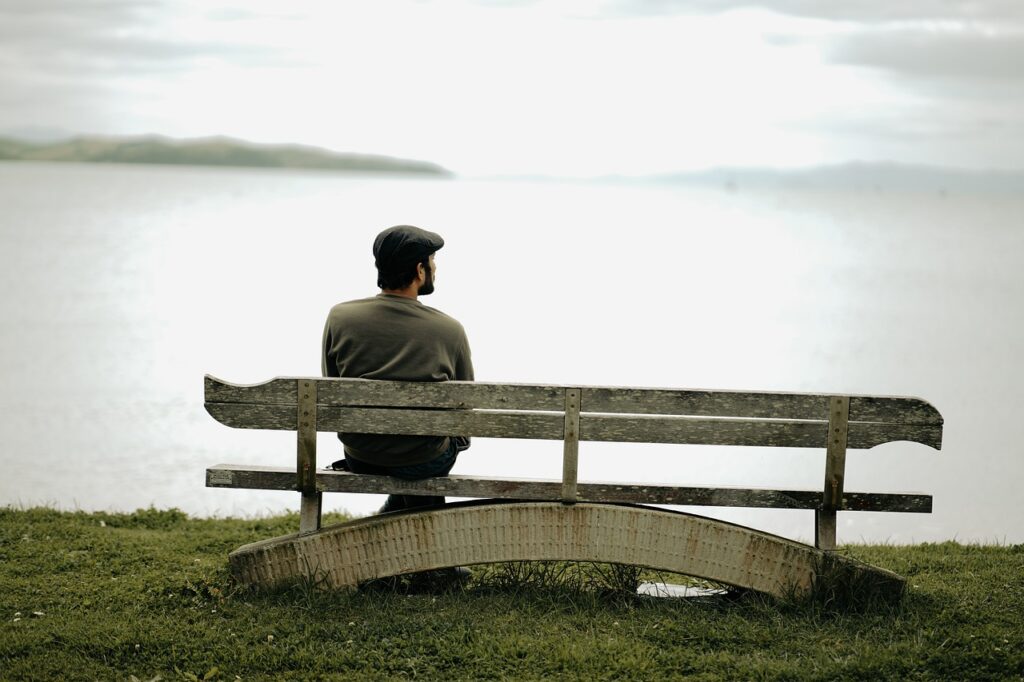 Man relaxing by a lake helps alleviate stress eating.